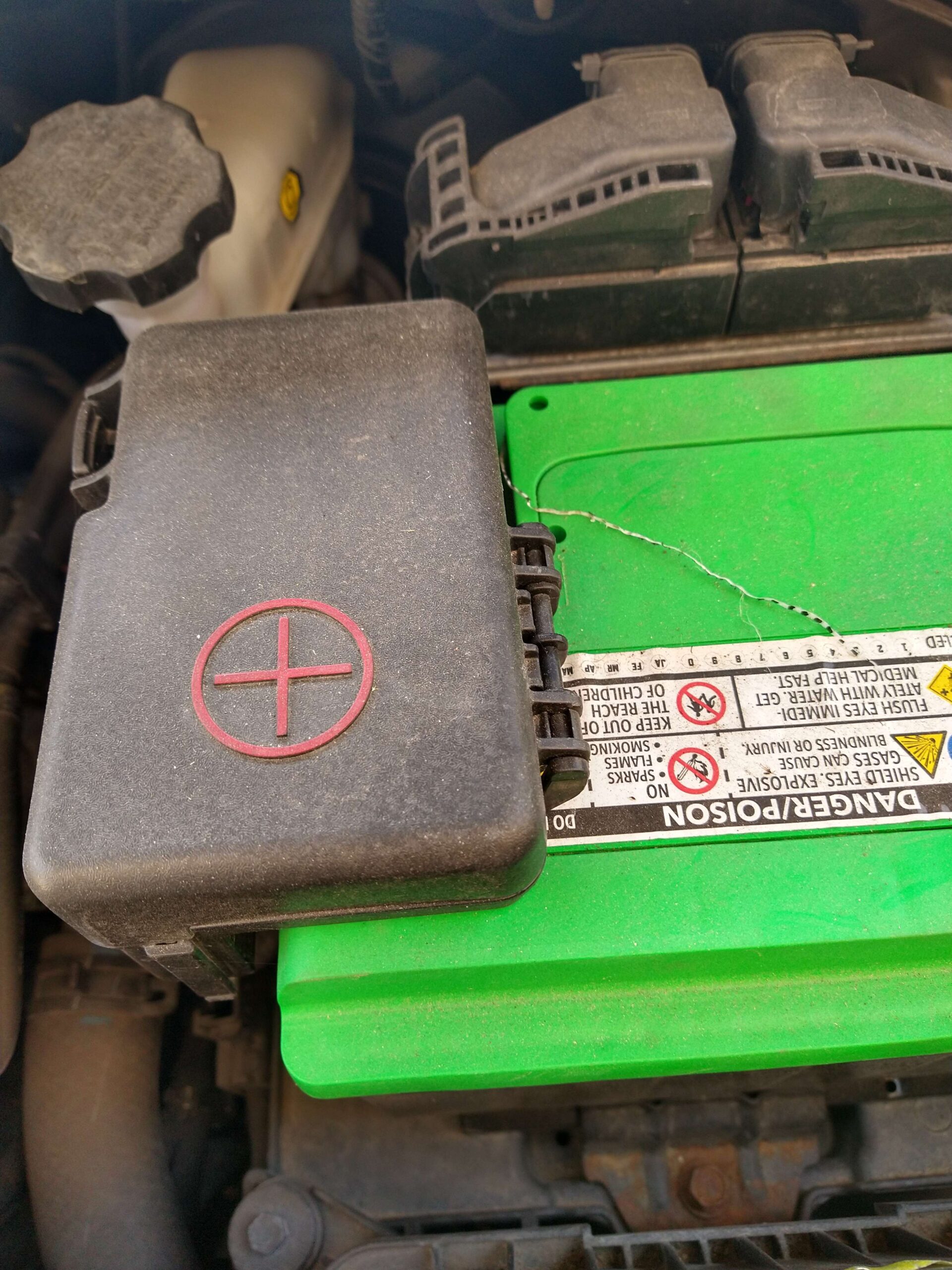 The positive terminal (marked with a red plus sign) of a traditional lead-acid battery