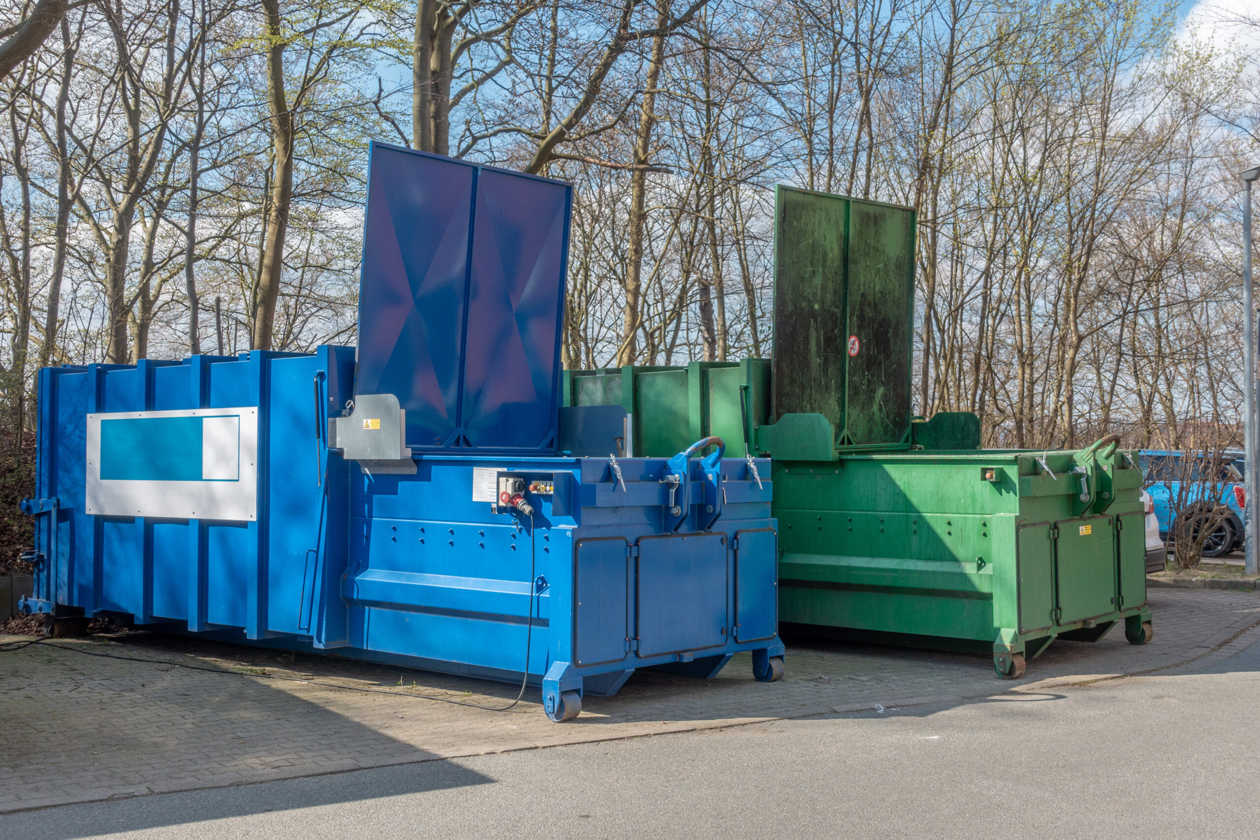 Blue and green dumpsters outside